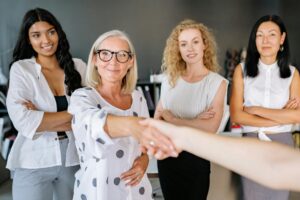 a woman shaking hands with another person