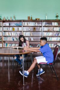 a boy and girl reading books